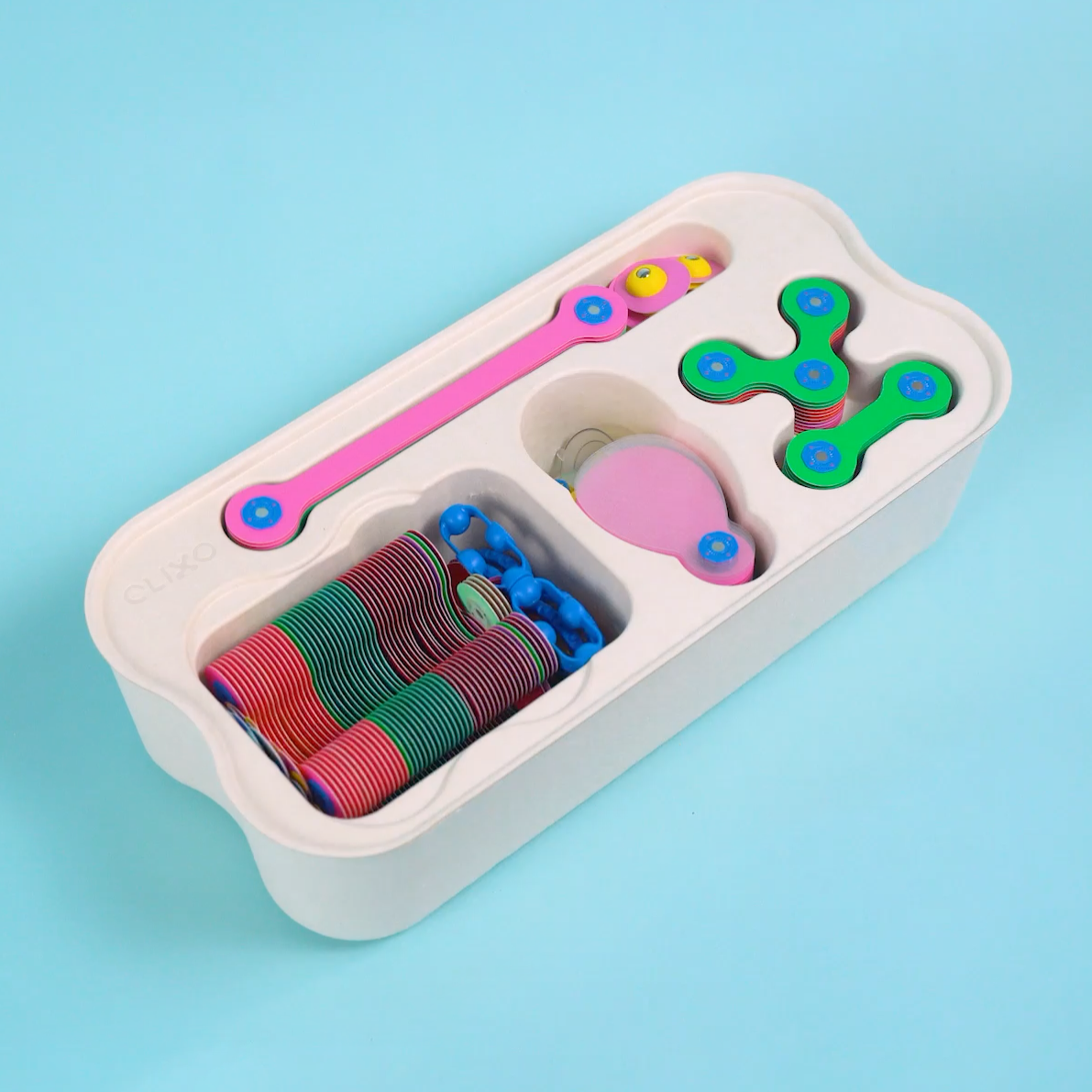 Clixo Family Pack and Expedition Bundle packaging with toy structures in the background.