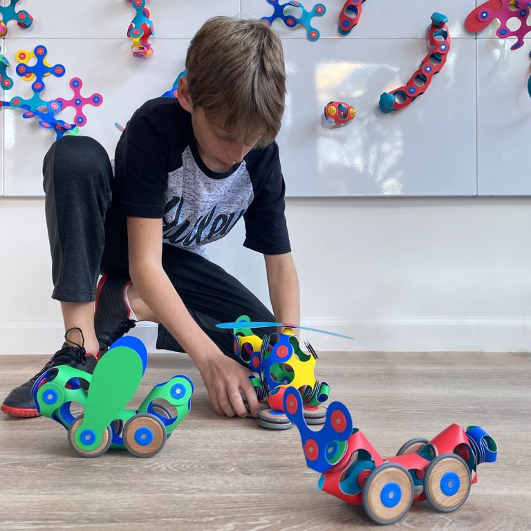 Clixo Wheel Creator Pack with various rolling toy creations made of colorful magnetic pieces.